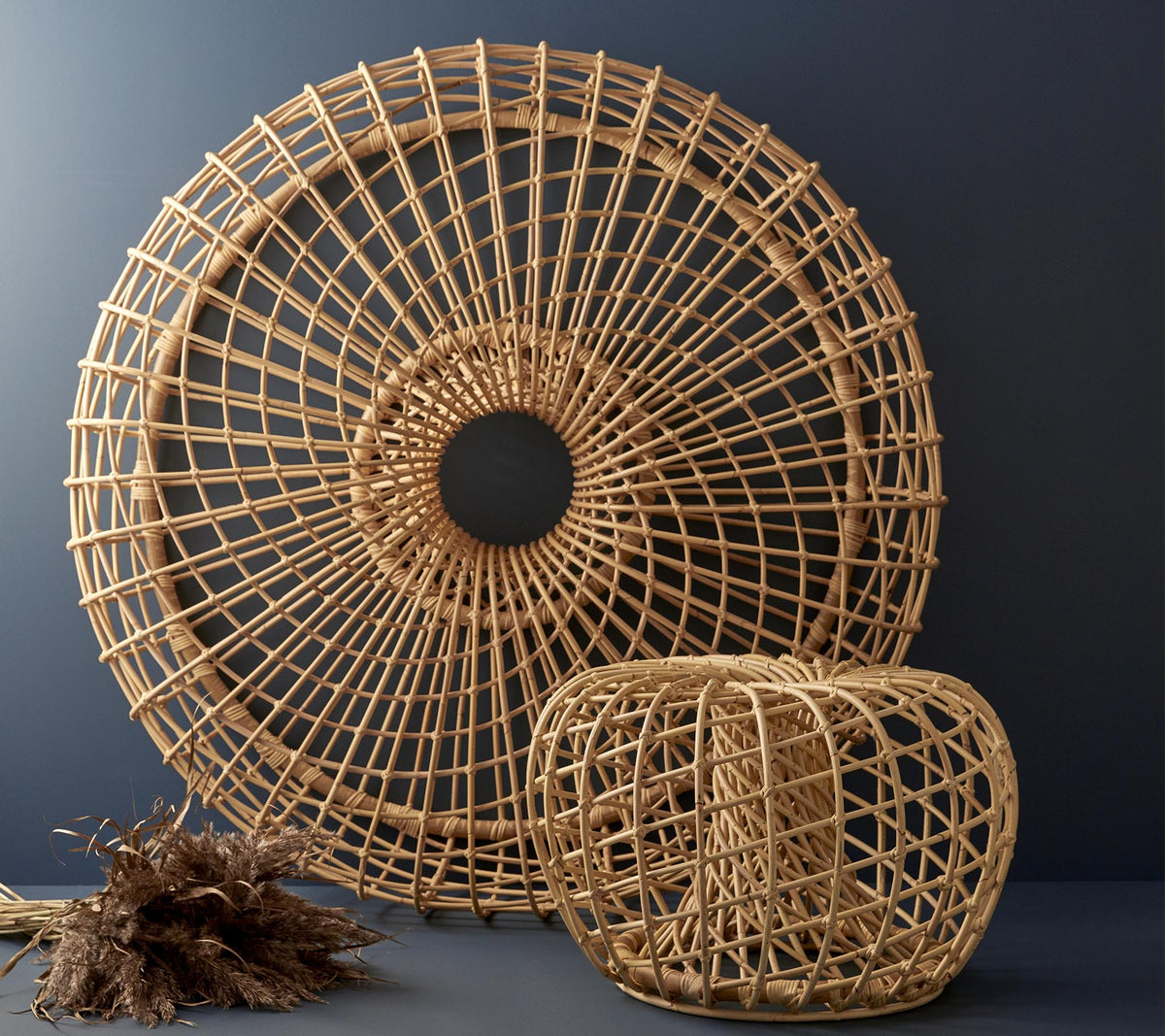 Woven rattan decor pieces in a circular shape and a cubical design, showcasing intricate patterns and natural textures.