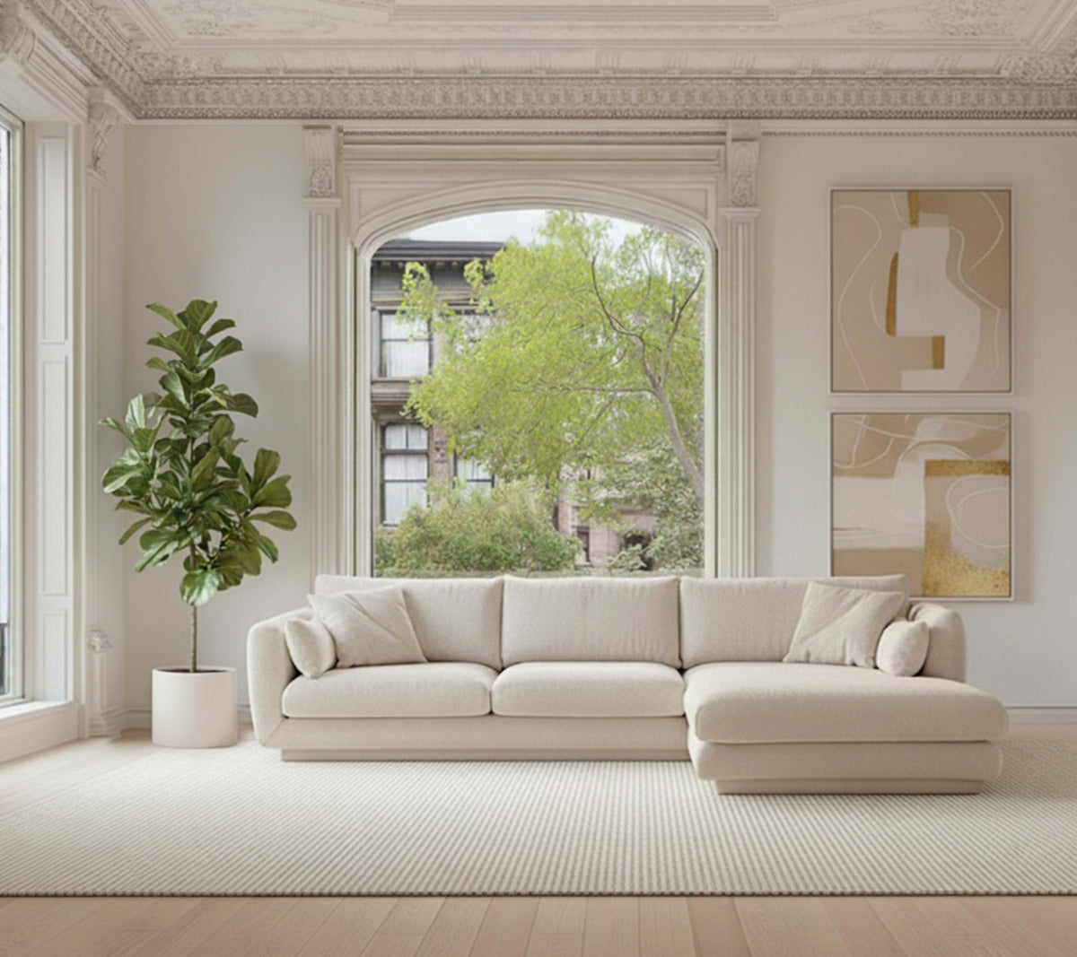 Beige sectional sofa with a green plant and white rug in a modern lounge setting.