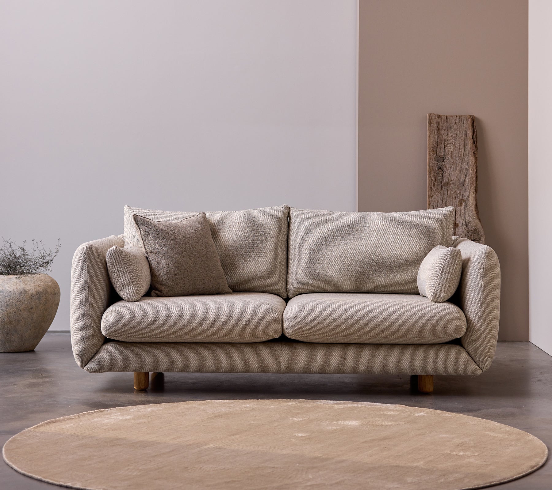 Bloom 2-seater sofa with teak legs in Desert Sand color, featuring plush cushions and a soft, minimalist design.