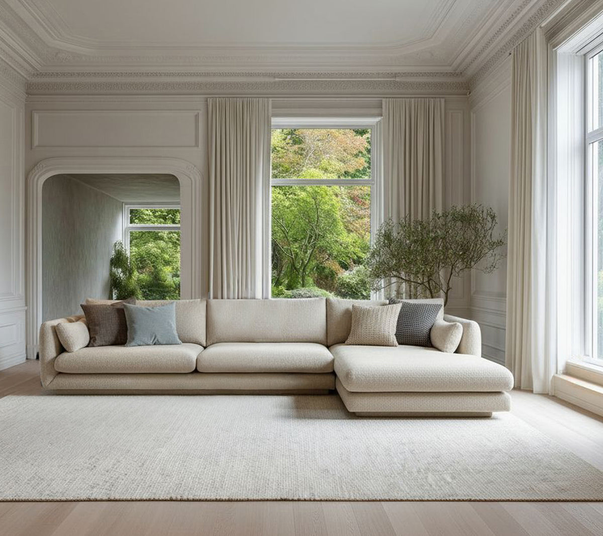 Beige modern sofa with grey cushions in a minimalist lounge setting.