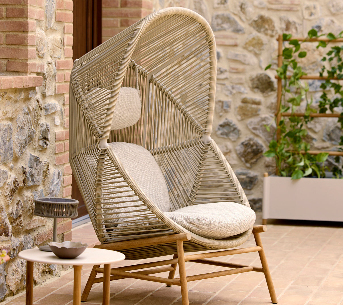 Stylish Hive chair in sand color featuring a unique twist design, complemented by plush cushions for comfort.
